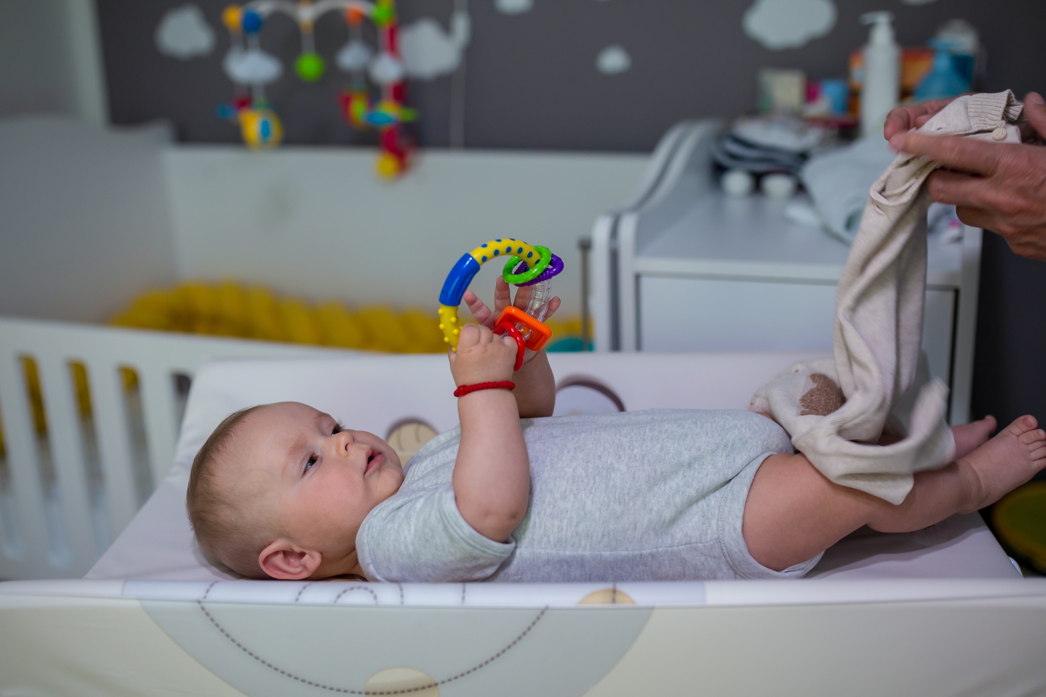 a baby using a toy to encourage pincer grasp in babies