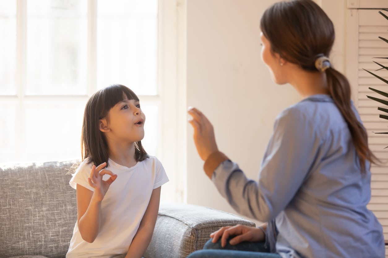 speech therapist working with a child with a pediatric voice disorder